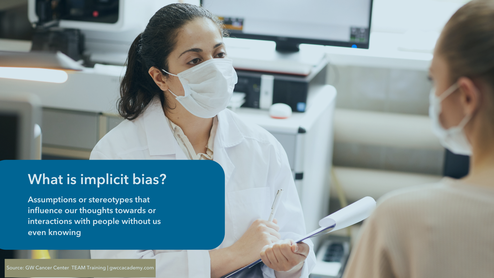 Image of female doctor wearing a mask speaking with a patient. Text description defines implicit bias. 